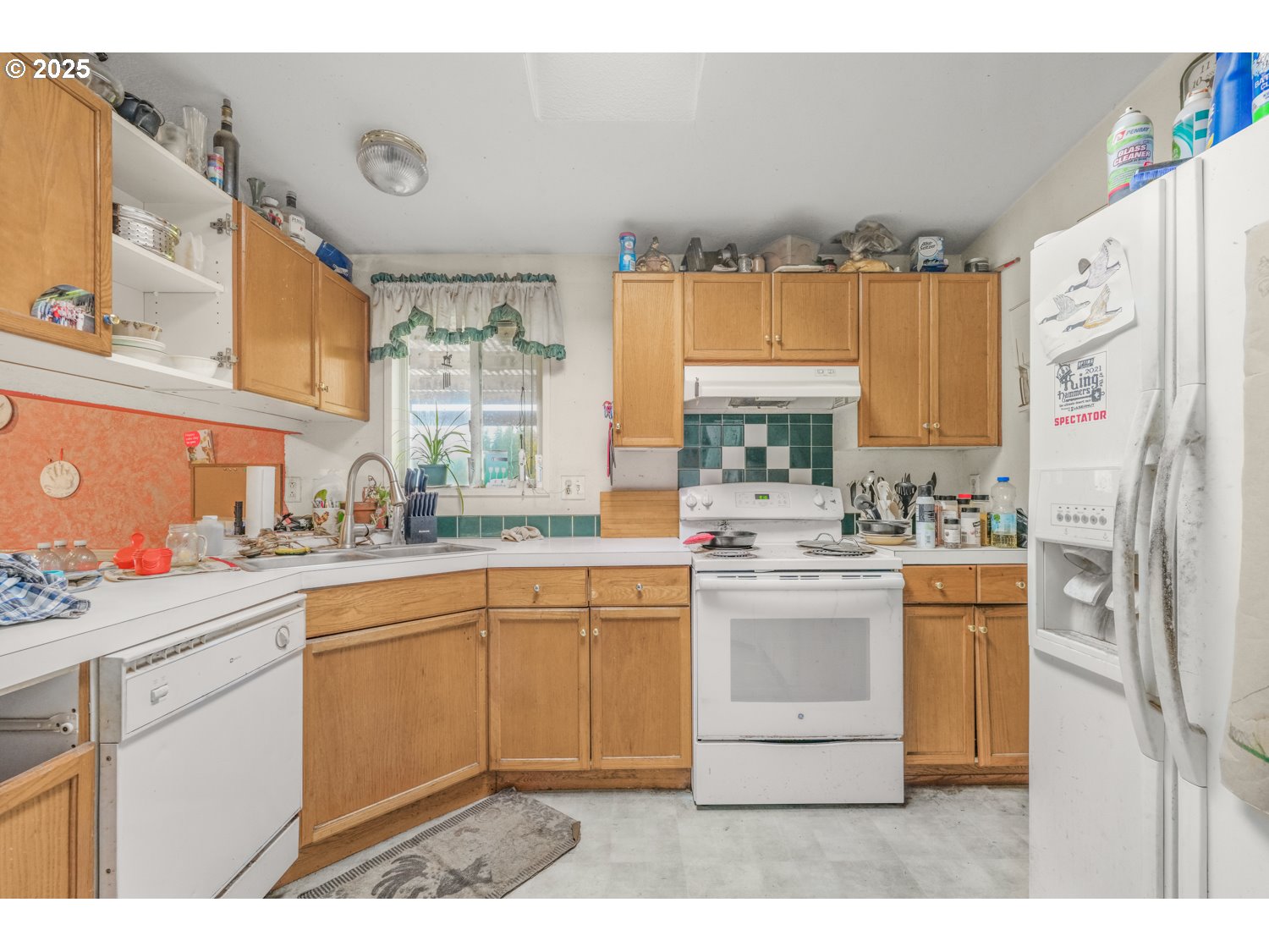 19807 Highway 211 Colton, OR 97017 - Photo 9 of 22 a kitchen with kitchen island white cabinets and white appliances