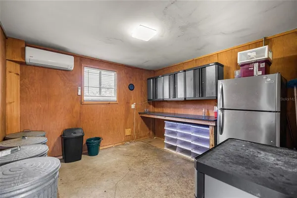a kitchen with a refrigerator and a sink