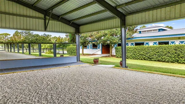 a view of a house with a backyard and a patio