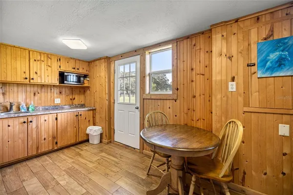 a view of a kitchen with a table and chairs