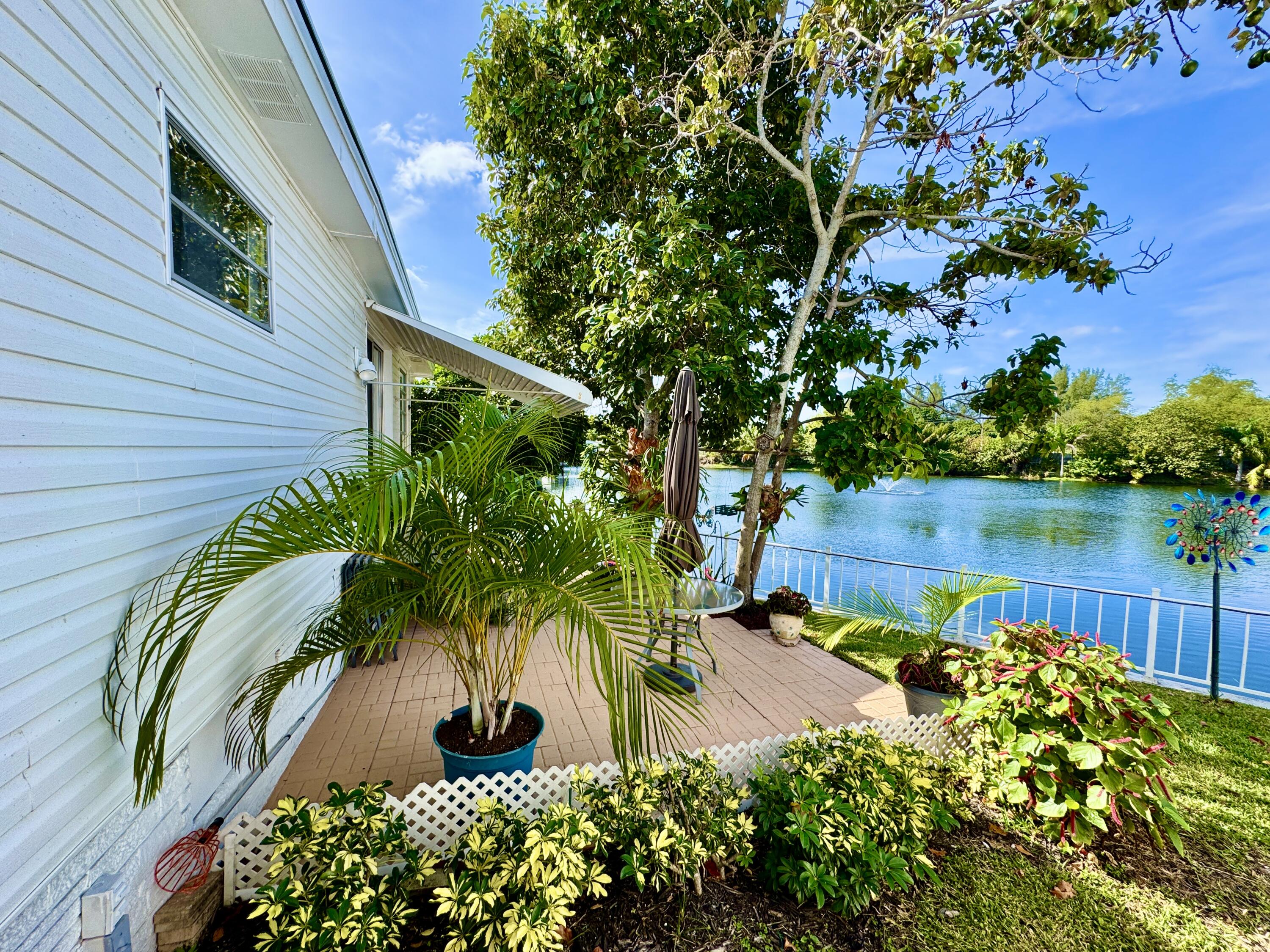 1324 South 33rd Road, Unit 1324 Hollywood, FL 33021 - Photo 18 of 23 a view of a garden with plants and a bench