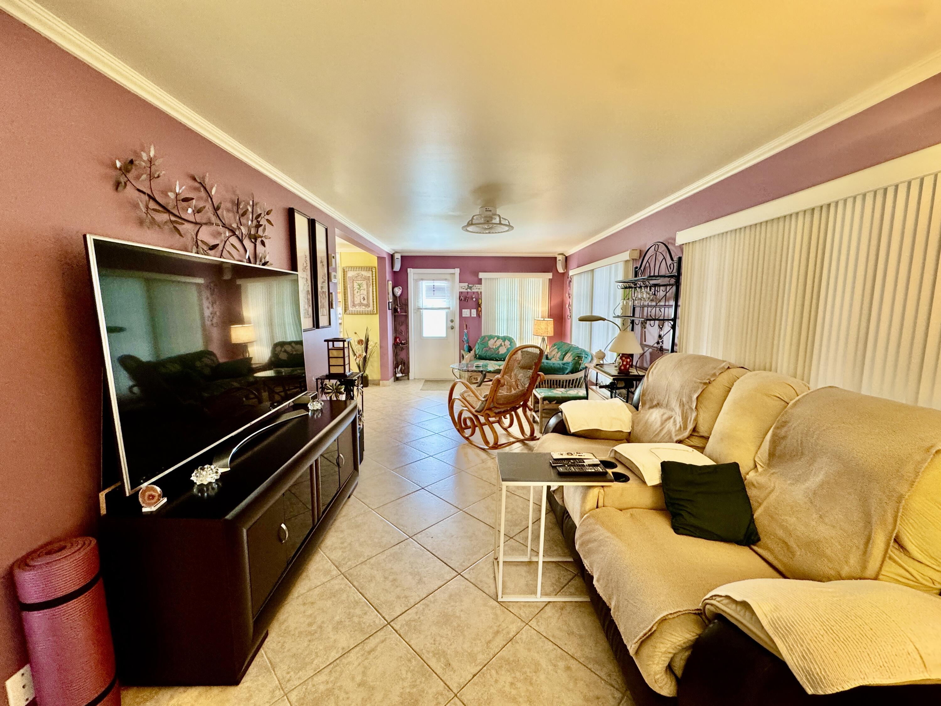 1324 South 33rd Road, Unit 1324 Hollywood, FL 33021 - Photo 5 of 23 a living room with furniture and a flat screen tv
