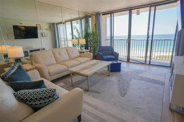 a living room with furniture and a chandelier