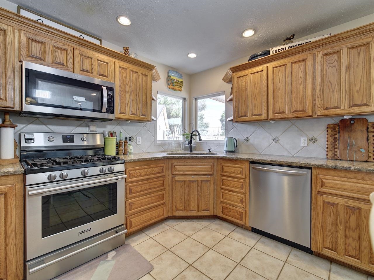970 20 Road Fruita, CO 81521 - Photo 8 of 31 a kitchen with stainless steel appliances granite countertop a stove sink microwave and cabinets