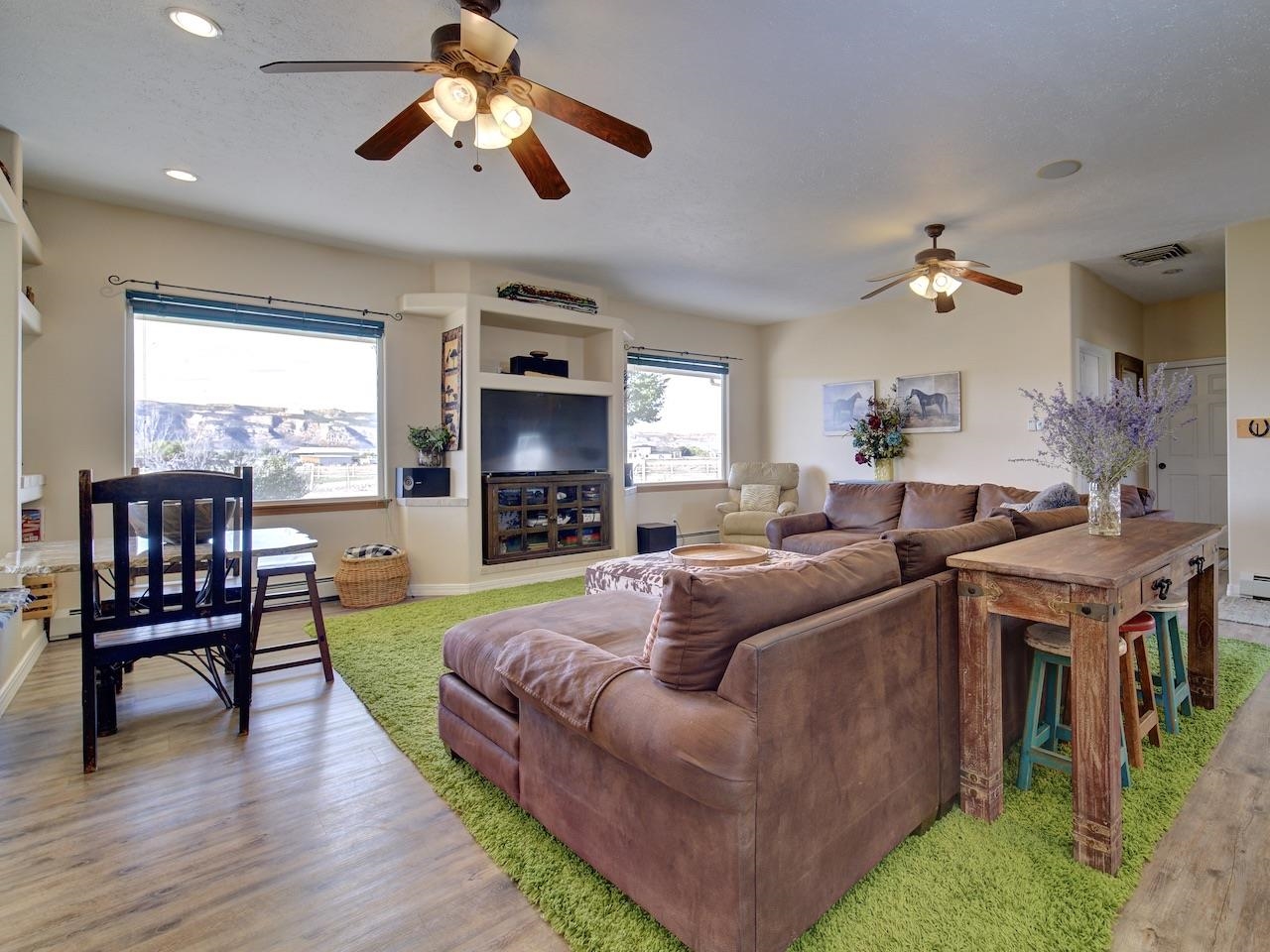 970 20 Road Fruita, CO 81521 - Photo 10 of 31 a living room with furniture a fireplace and a flat screen tv