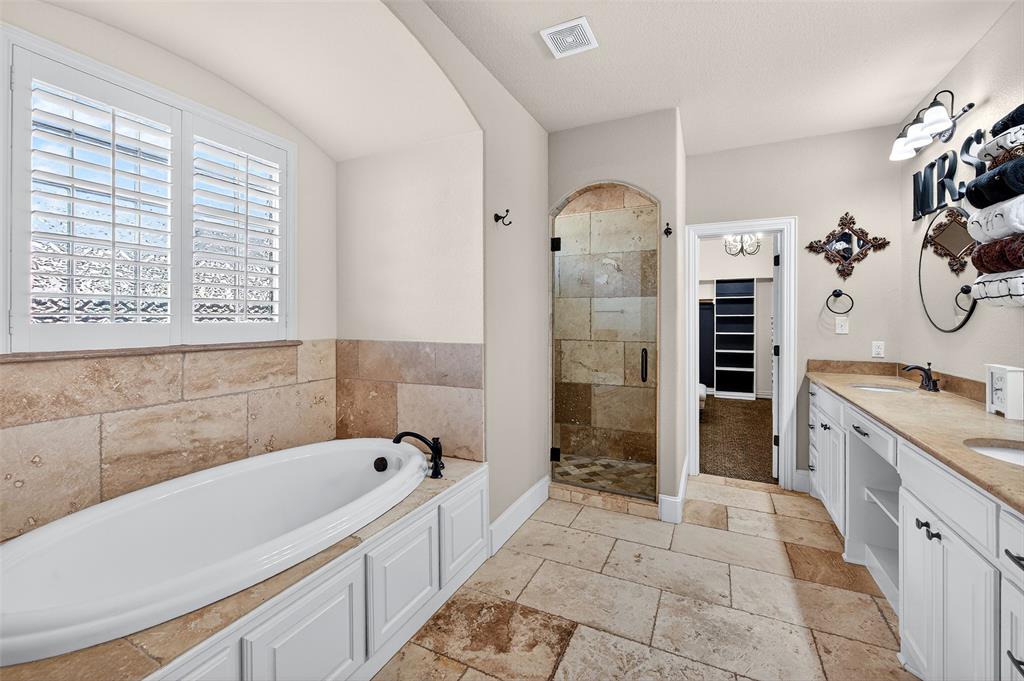 2420 Remuda Drive Sherman, TX 75092 - Photo 20 of 40 a bathroom with a tub sink and mirror
