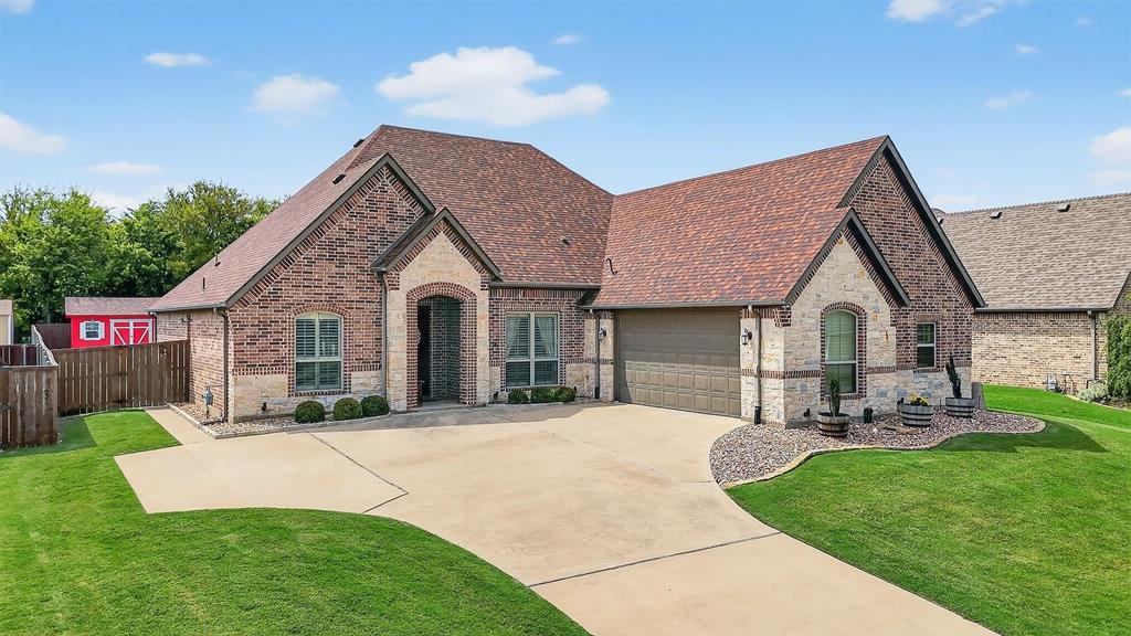 2420 Remuda Drive Sherman, TX 75092 - Photo 2 of 40 a front view of a house with a yard and garage