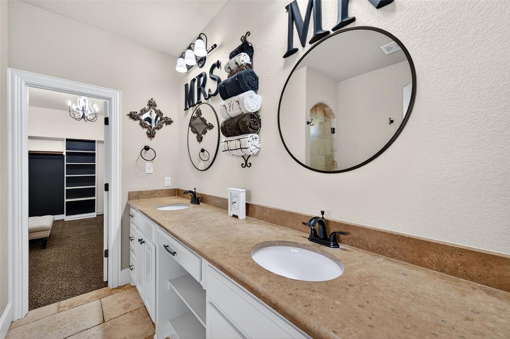 2420 Remuda Drive Sherman, TX 75092 - Photo 21 of 40 a bathroom with a granite countertop double vanity sinks and a mirror
