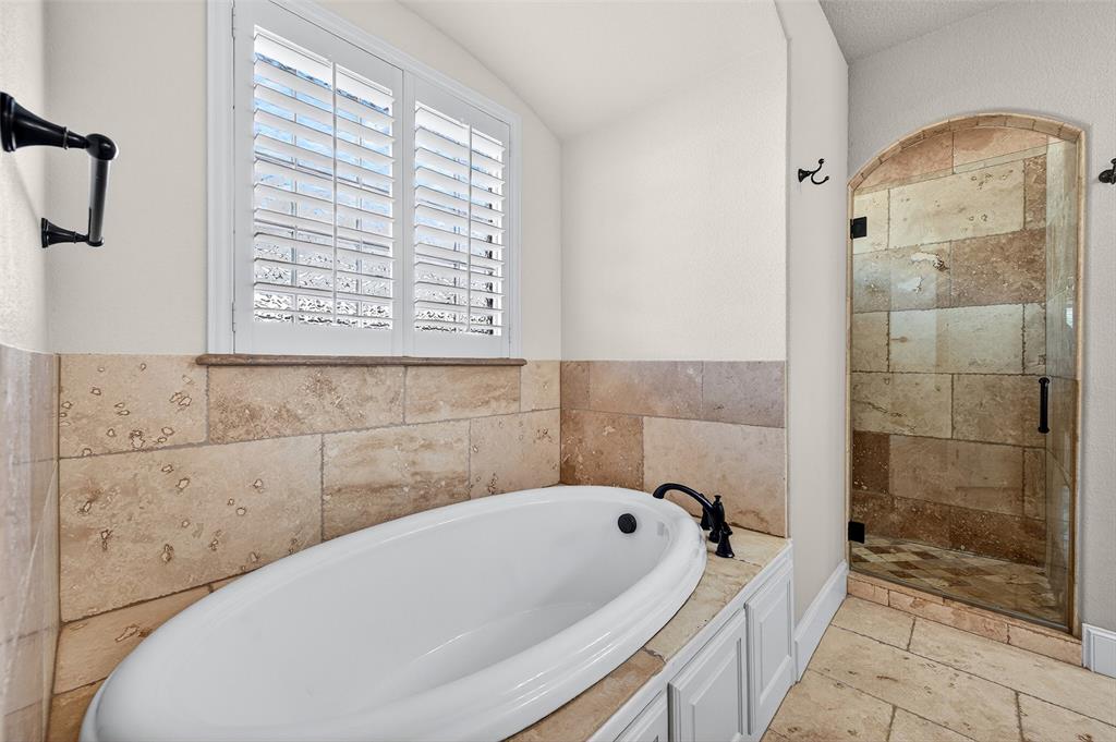 2420 Remuda Drive Sherman, TX 75092 - Photo 22 of 40 a bathroom with a bathtub and a shower