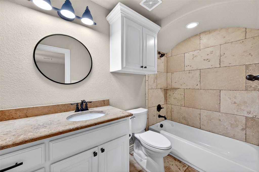 2420 Remuda Drive Sherman, TX 75092 - Photo 27 of 40 a bathroom with a sink a toilet and a mirror