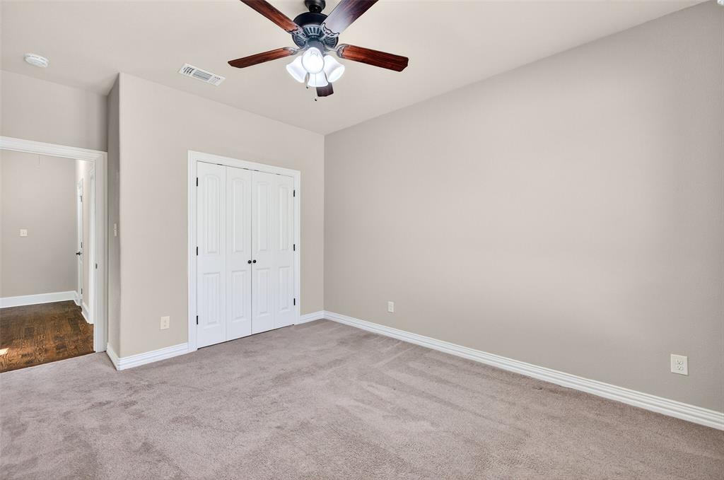 2420 Remuda Drive Sherman, TX 75092 - Photo 29 of 40 an empty room with a chandelier fan and a chandelier fan