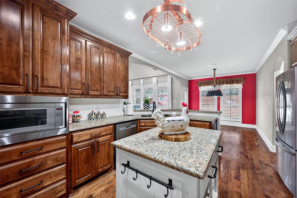 2420 Remuda Drive Sherman, TX 75092 - Photo 7 of 40 a kitchen with stainless steel appliances granite countertop a sink dishwasher and cabinets with wooden floor