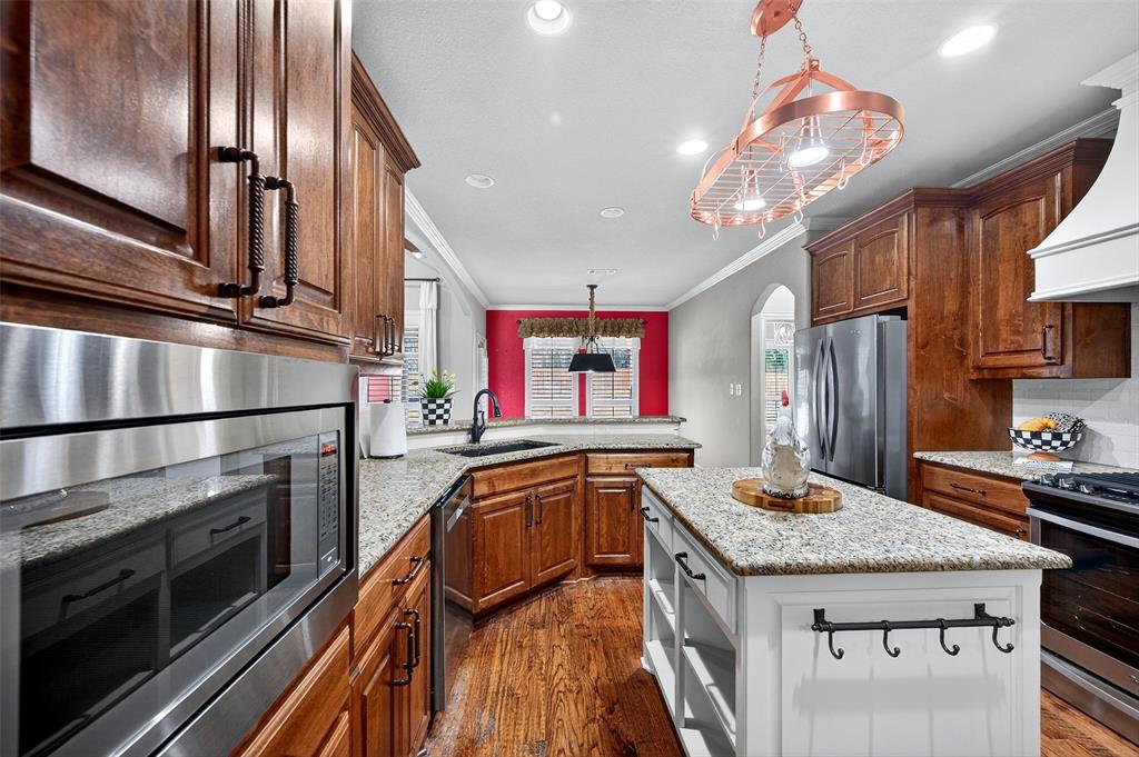 2420 Remuda Drive Sherman, TX 75092 - Photo 9 of 40 a kitchen with kitchen island granite countertop stainless steel appliances lots of counter top space