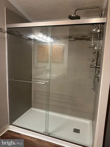 a bathroom with a glass shower door