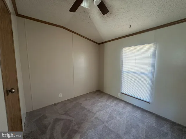 an empty room with closet and windows