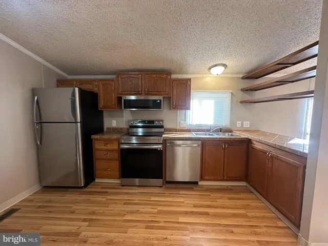 a kitchen with a refrigerator and a sink