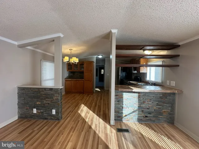 a view of living room kitchen and entryway