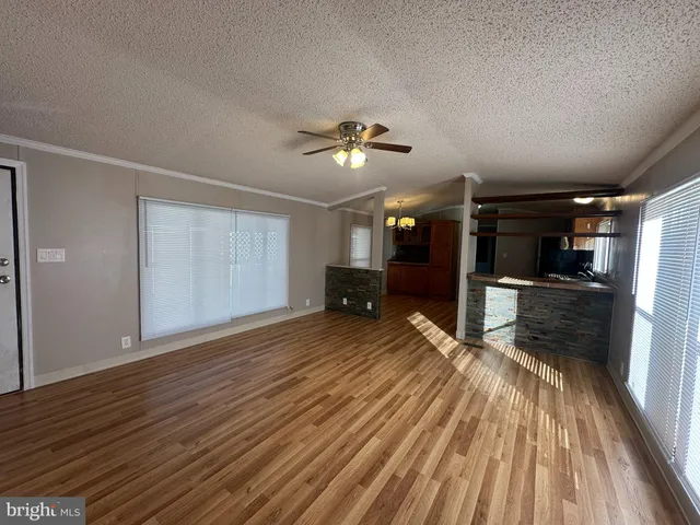 a view of a room with wooden floor