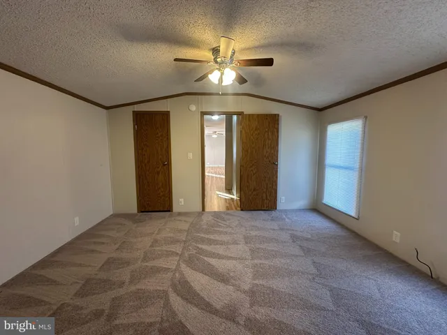 a view of a livingroom with a ceiling fan and window