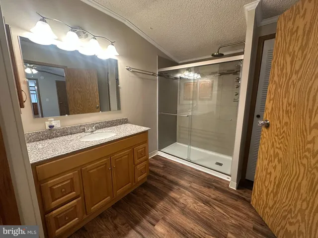 a bathroom with a granite countertop sink mirror and shower