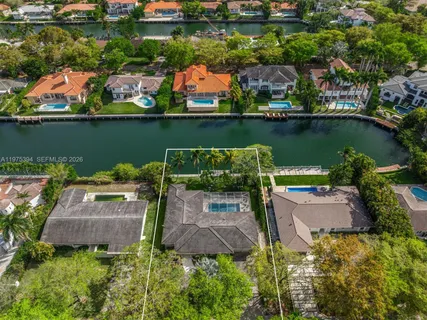 an aerial view of a house with a lake view