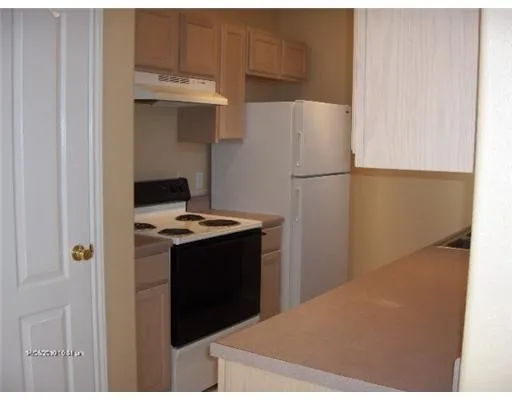 a kitchen with a refrigerator and a stove