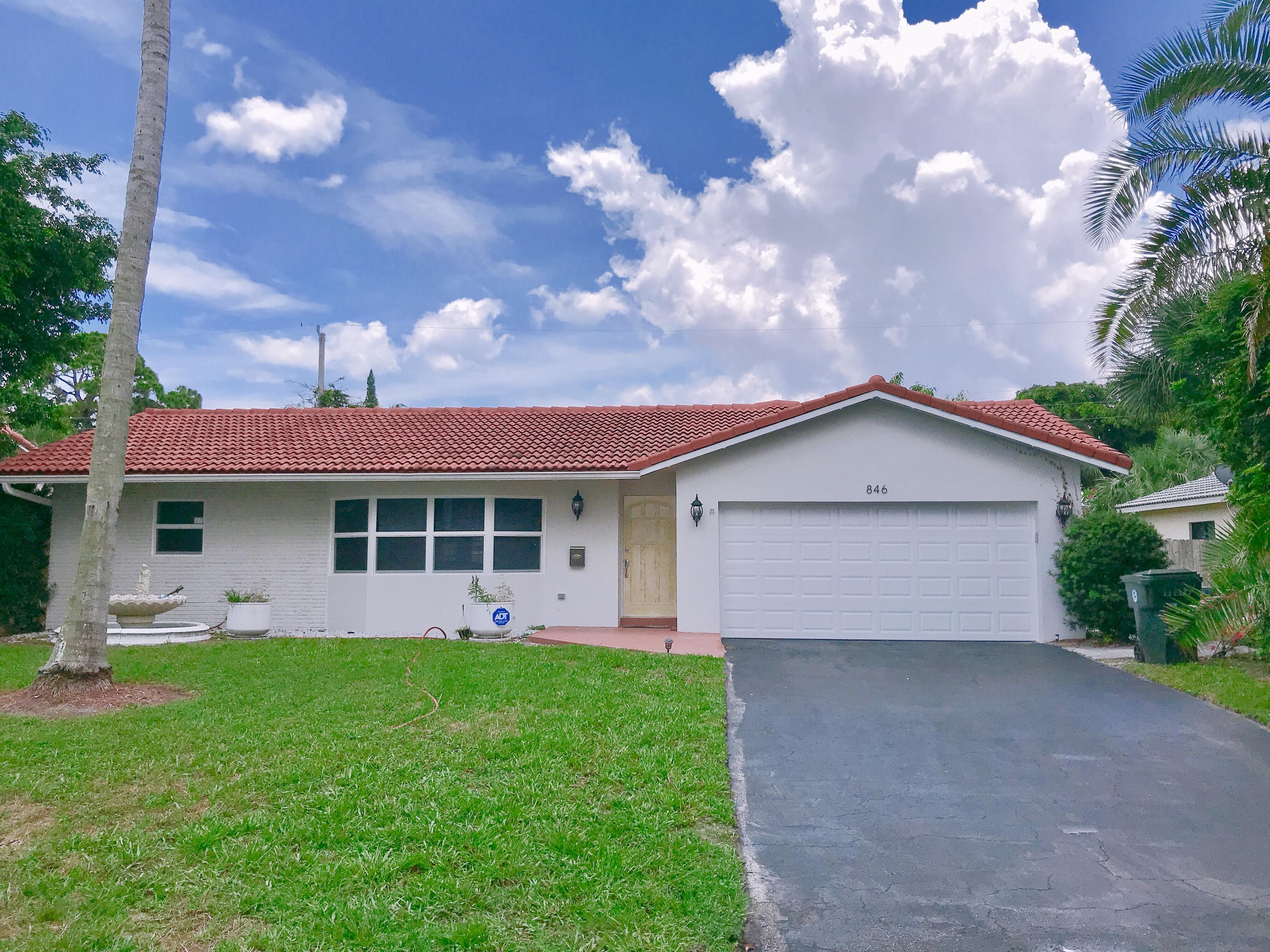 846 Northwest 7th Street Boca Raton, FL 33486 - Photo 1 of 19 a front view of a house with garden