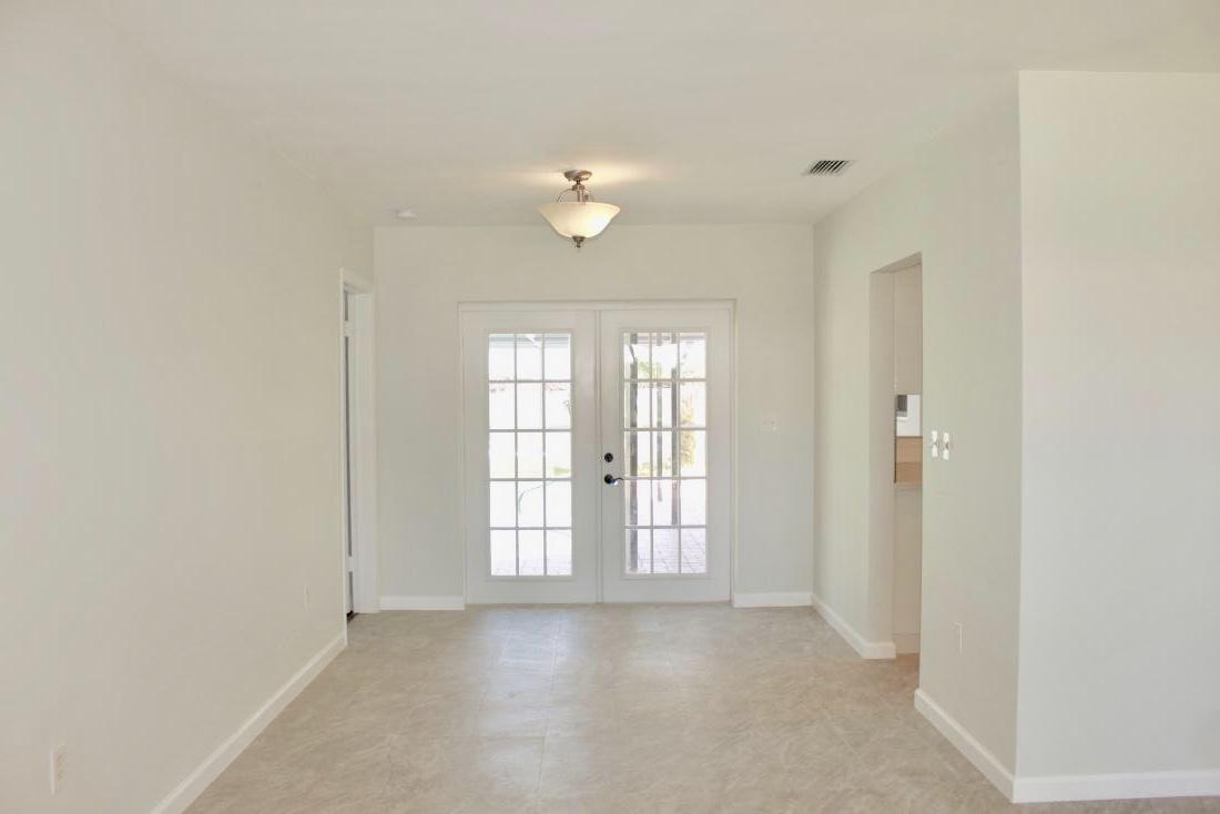 846 Northwest 7th Street Boca Raton, FL 33486 - Photo 11 of 19 an empty room with chandelier fan and windows