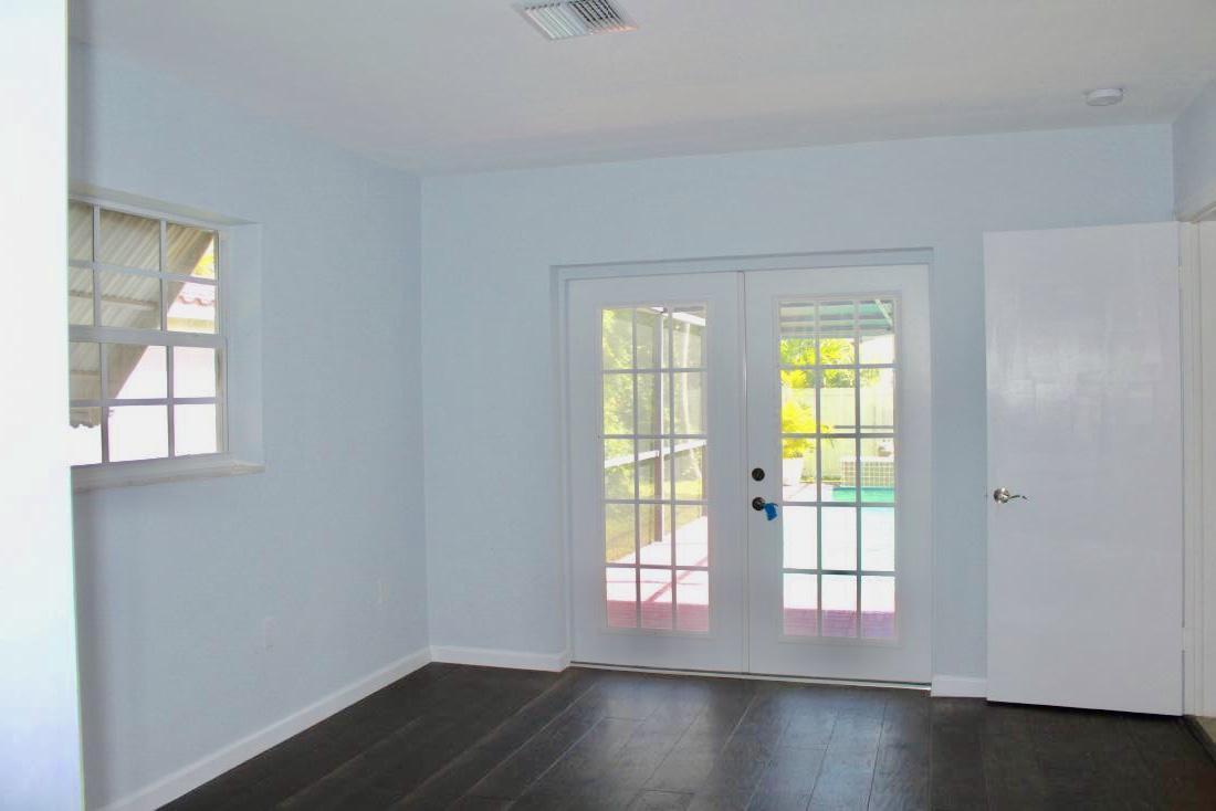 846 Northwest 7th Street Boca Raton, FL 33486 - Photo 16 of 19 an empty room with wooden floor and windows