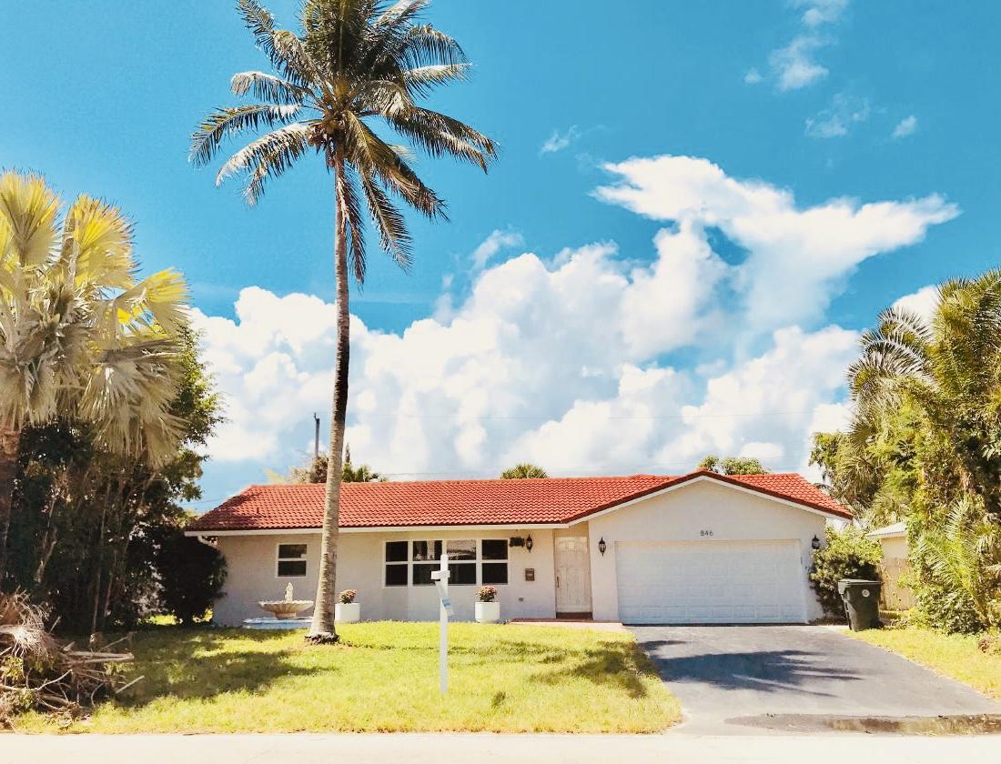 846 Northwest 7th Street Boca Raton, FL 33486 - Photo 4 of 19 a front view of a house with garden