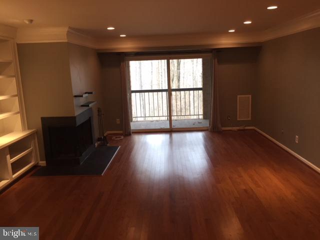 5800 Cove Landing Road, Unit 303 Burke, VA 22015 - Photo 7 of 25 living room, w/balcony, fp, built ins