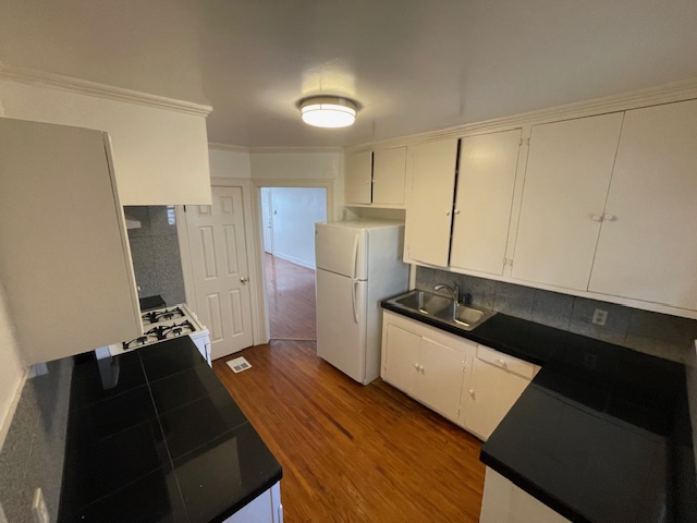 2104 Enfield Road, Unit A Austin, TX 78703 - Photo 4 of 13 a kitchen with granite countertop a refrigerator and a stove
