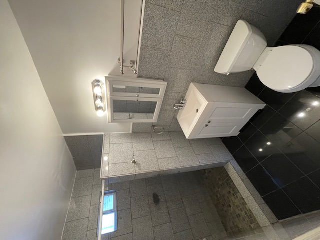 2104 Enfield Road, Unit A Austin, TX 78703 - Photo 10 of 13 a bathroom with a sink toilet and shower