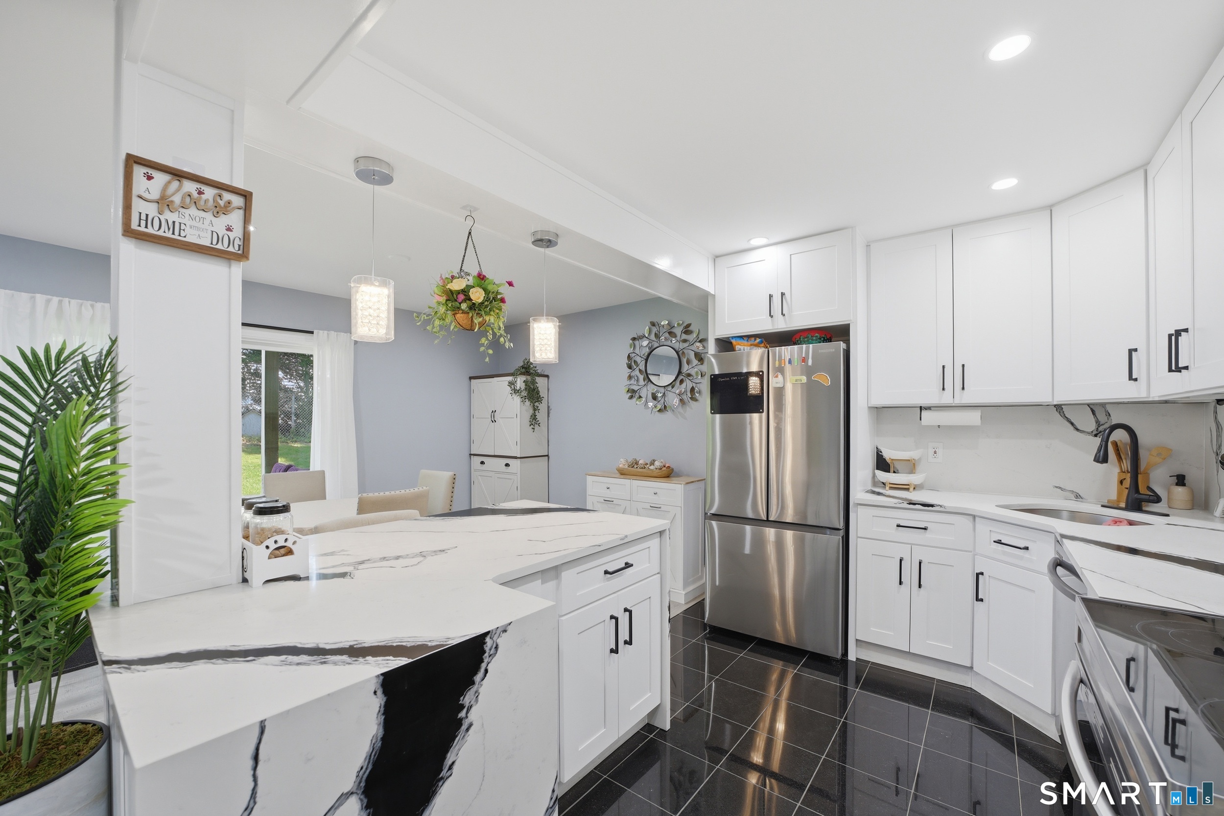 187 Flax Hill Road, Unit D1 Norwalk, CT 06854 - Photo 7 of 32 a kitchen with a sink stainless steel appliances and white cabinets