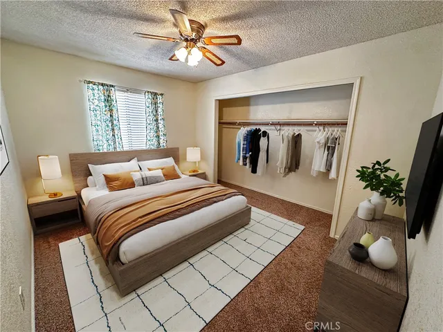 a bedroom with a large bed and a chandelier
