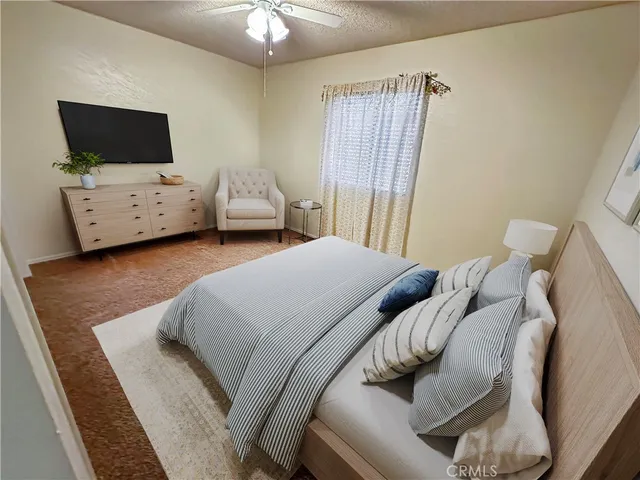 a bedroom with furniture and a flat screen tv
