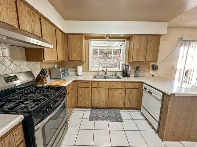 a kitchen with a sink stove top oven and cabinets