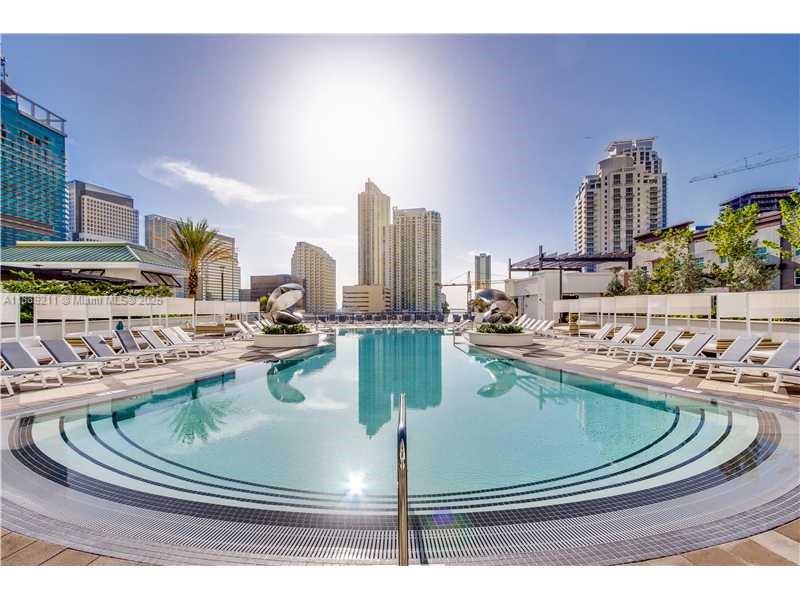 999 Southwest 1st Avenue, Unit 2103 Miami, FL 33130 - Photo 15 of 16 a view of a swimming pool with outdoor seating