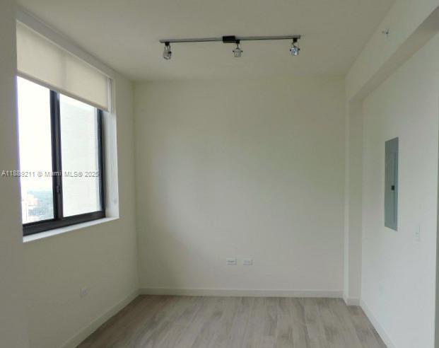 999 Southwest 1st Avenue, Unit 2103 Miami, FL 33130 - Photo 3 of 16 a view of a small space with wooden floor and a window
