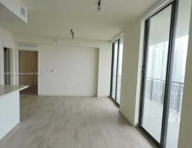 a view of a room with an empty space and a hallway