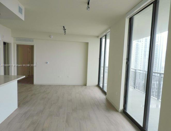 999 Southwest 1st Avenue, Unit 2103 Miami, FL 33130 - Photo 4 of 16 a view of a room with an empty space and a hallway