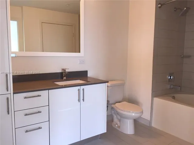 a bathroom with a sink a toilet and bathtub