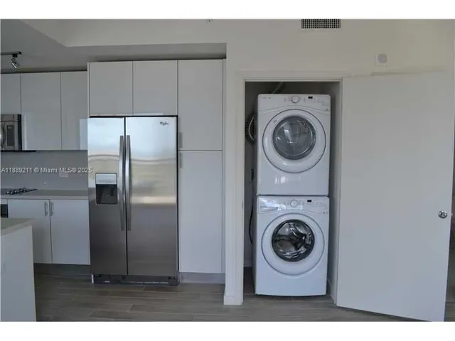 a utility room with sink dryer and washer