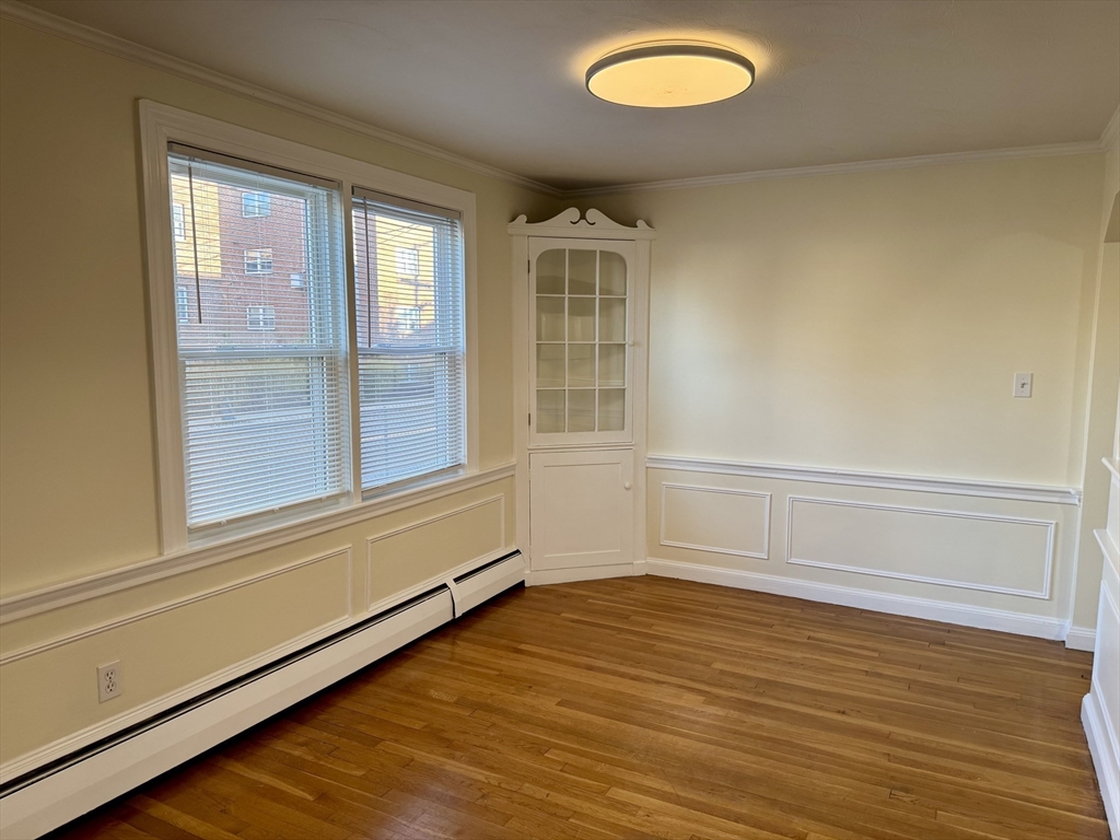 40 Gardner Street, Unit 1 Boston, MA 02132 - Photo 2 of 8 a view of an empty room with a window and wooden floor