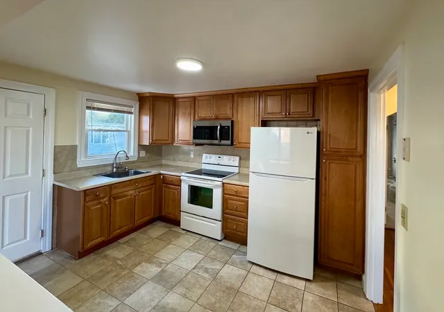 a kitchen with a refrigerator sink and microwave