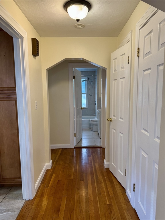 40 Gardner Street, Unit 1 Boston, MA 02132 - Photo 5 of 8 a view of a hallway with wooden floor and staircase
