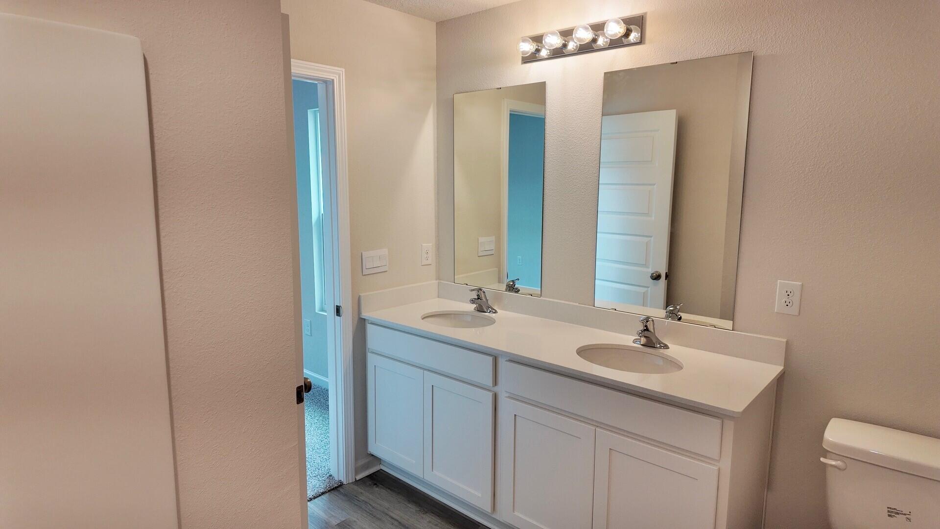 8029 Fir Tree Drive Milton, FL 32583 - Photo 16 of 41 a bathroom with a double vanity sink and a mirror