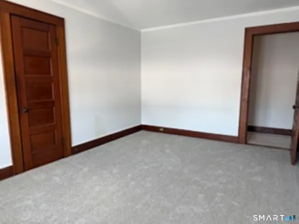 a view of an empty room and closet area