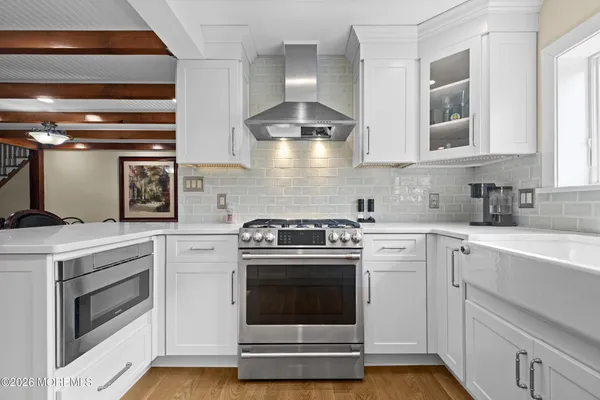 a kitchen with a stove top oven and cabinets