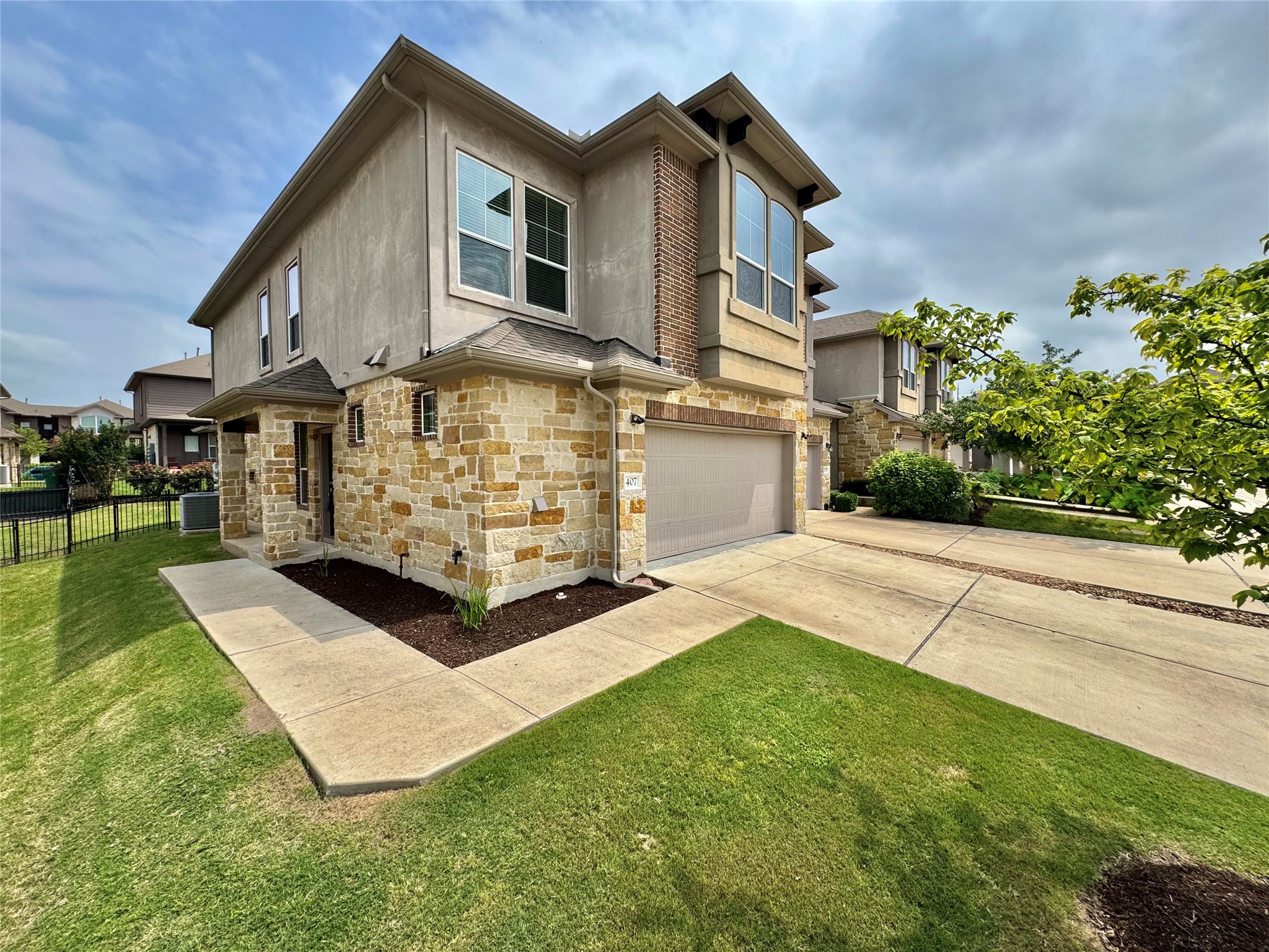 407 Rhetoric Way Pflugerville, TX 78660 - Photo 2 of 38 a view of a white house with a big yard and potted plants
